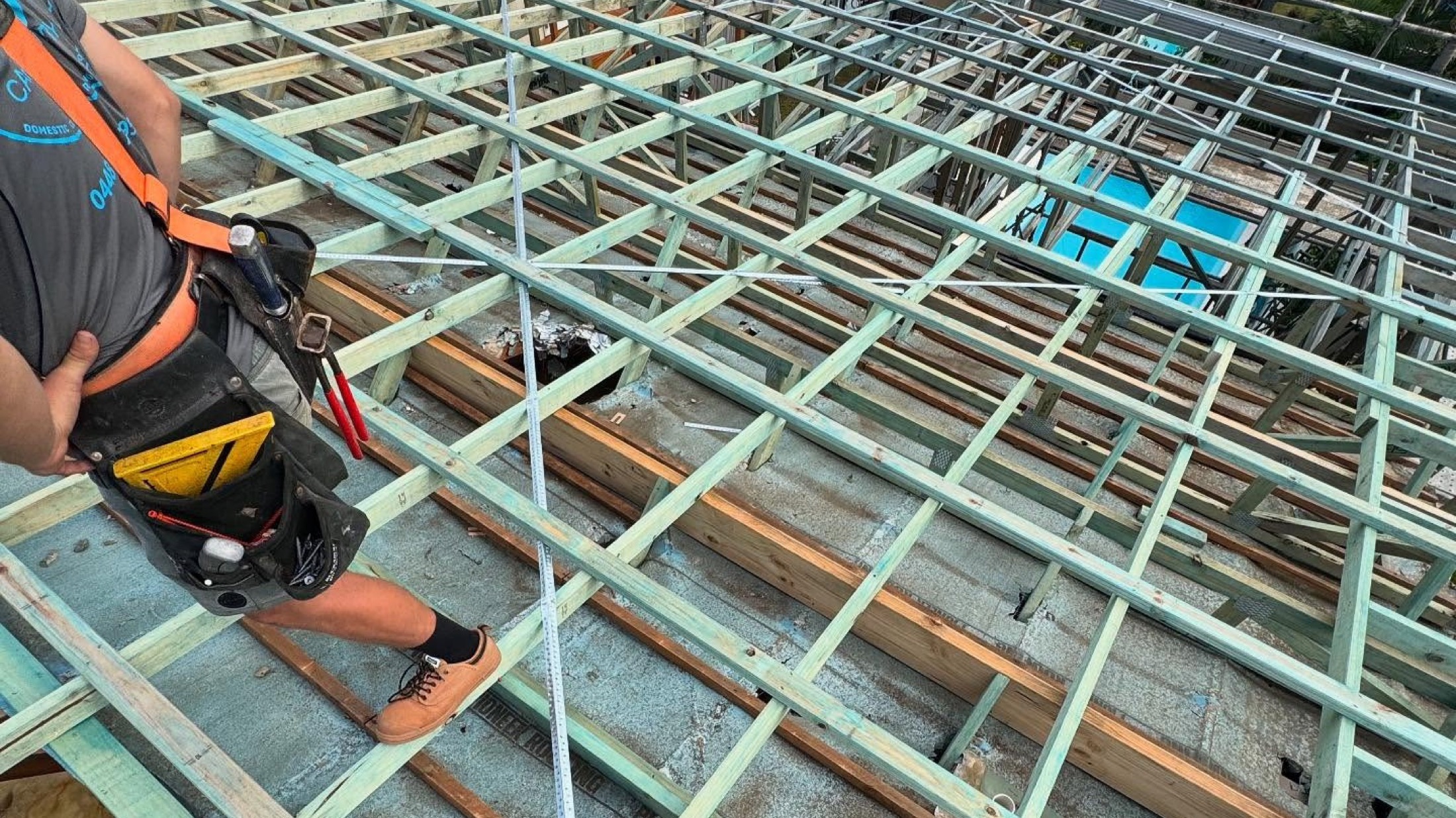 A timber and steel roof frame being set out, seen from above