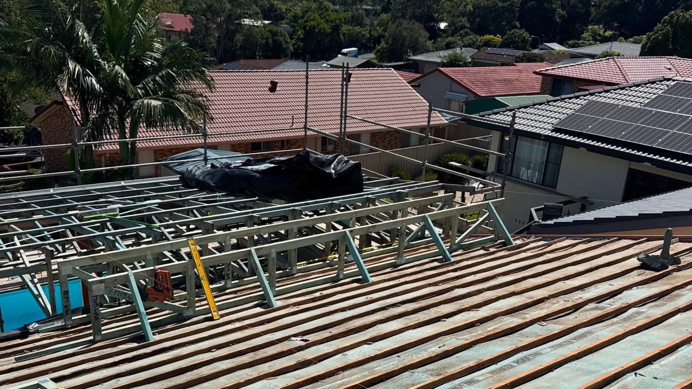 A roof frame of steel battens set out over a house, seen from above