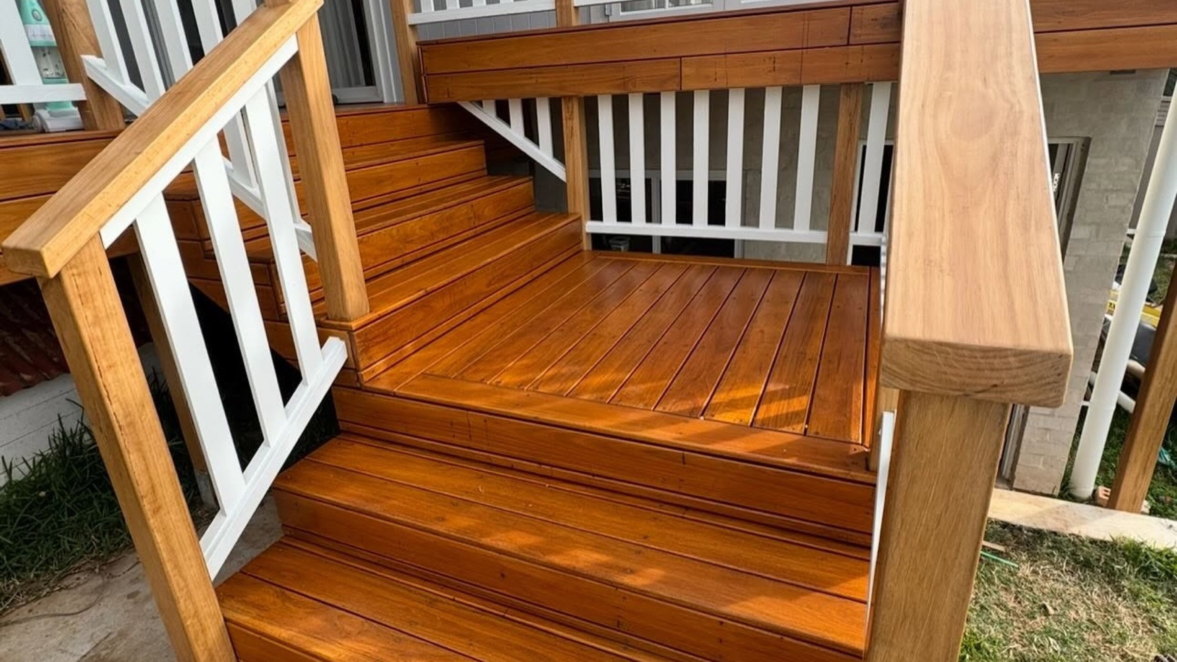 Timber stairs and a white balustrade built onto a hardwood deck
