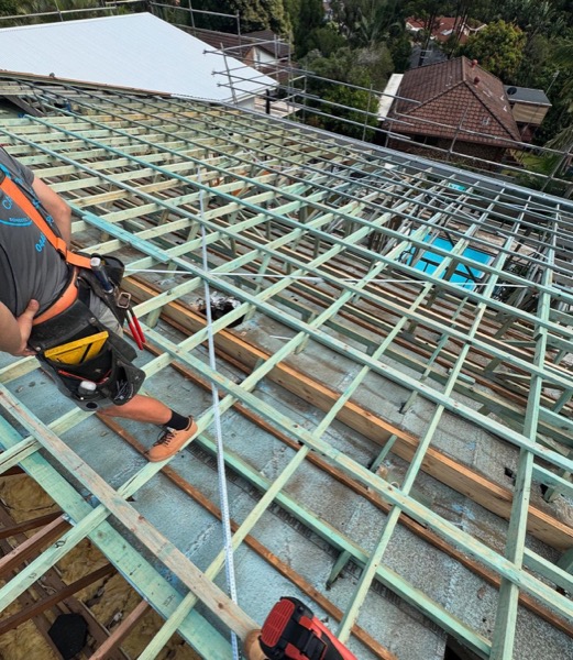 A timber and steel roof frame set out, seen from above