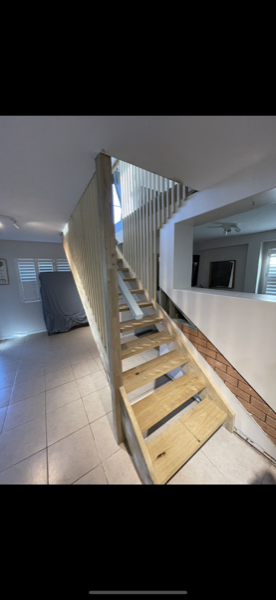 An internal staircase with a painted balustrade