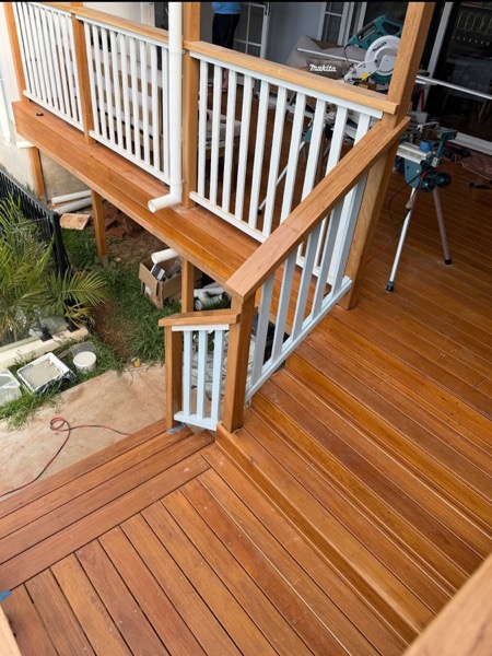 Timber stair treads and a balustrade being fitted on site