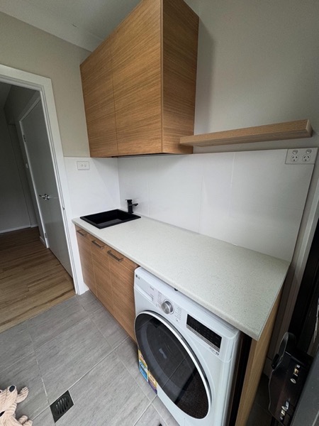 Laundry joinery with timber cabinetry and an appliance recess
