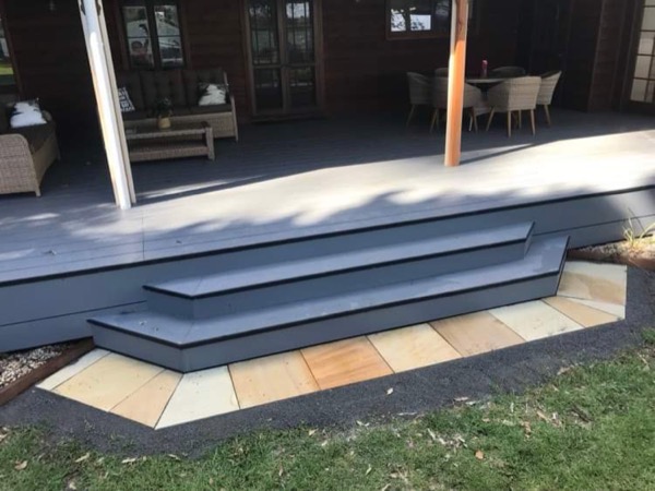 A deck with steps down onto paving