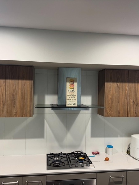 A room with timber cabinetry and a recessed alcove