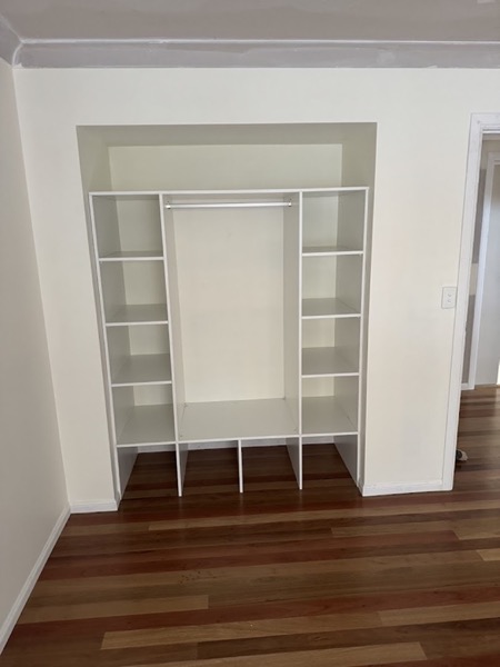 A built in wardrobe with shelving installed