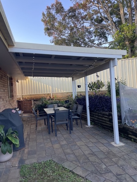 A patio roof over an outdoor setting