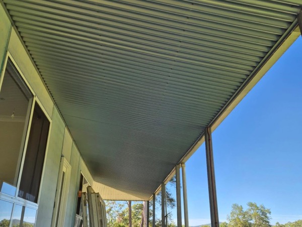 A new patio roof seen from underneath against the sky